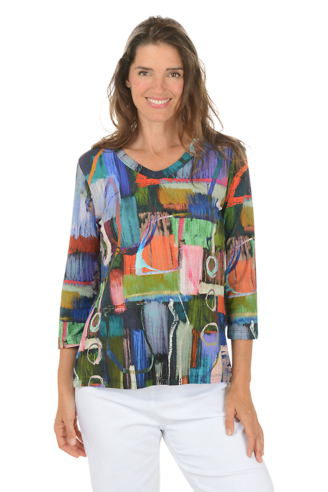 Woman wearing a colorful abstract patterned top on a white background.