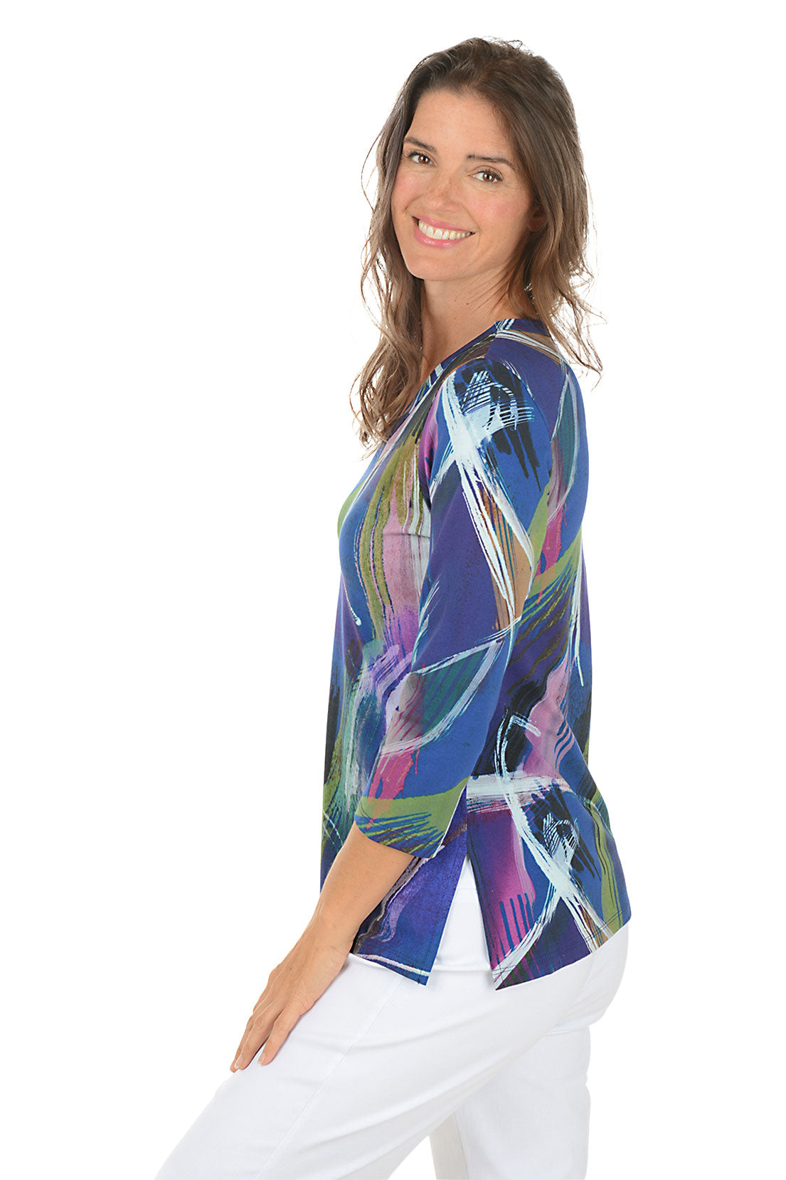 Woman wearing a colorful abstract patterned top on a white background. Side shot.