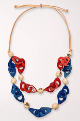 Necklace with red, blue, and beige floral-shaped beads on a white background