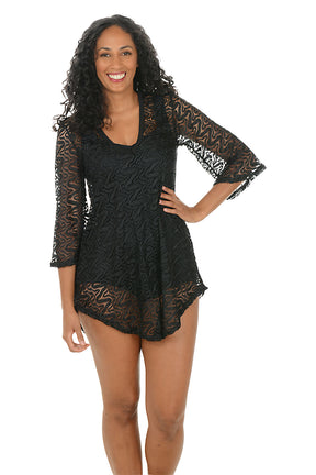 Woman wearing a black lace dress on a white background.