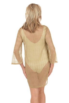 Woman wearing a gold lace cover-up on a white background. Back shot.