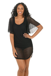 Woman wearing a black outfit with mesh sleeves and shorts on a white background.