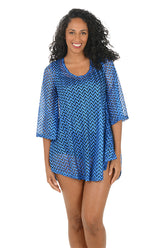 Woman wearing a blue chevron patterned cover-up on a white background.