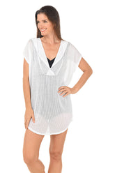 Woman wearing a white cover-up on a white background.