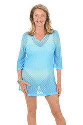 Woman wearing a blue gradient tunic on a white background.