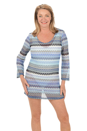 Woman wearing a patterned dress on a white background.