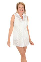 Woman wearing a white sleeveless dress on a white background.