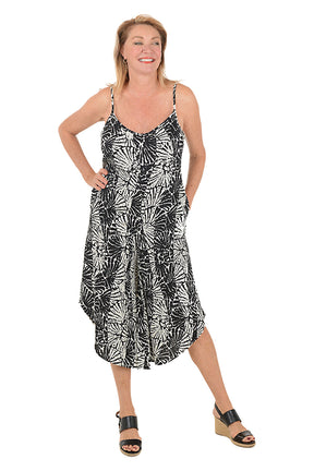 Woman wearing a black and white patterned dress on a white background.