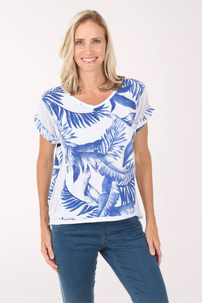 Woman wearing a blue and white patterned shirt with blue jeans on a white background