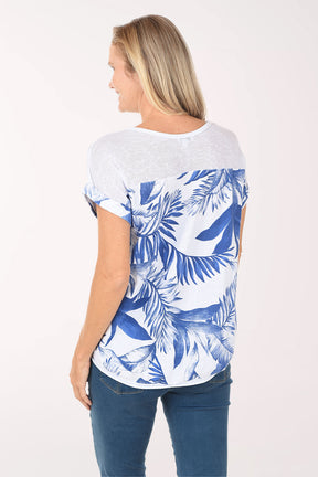 Woman wearing a blue and white patterned shirt with blue jeans on a white background