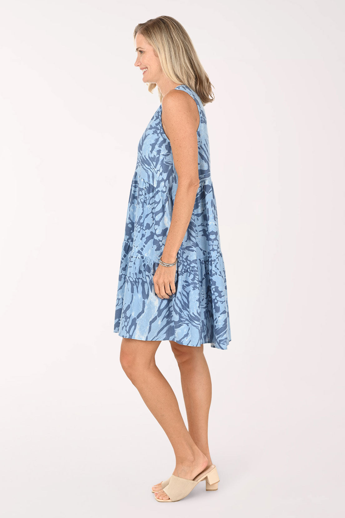 Woman wearing a blue sleeveless dress 