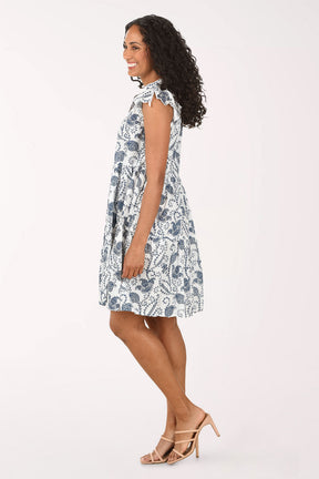 Woman wearing a sleeveless floral dress on a white background