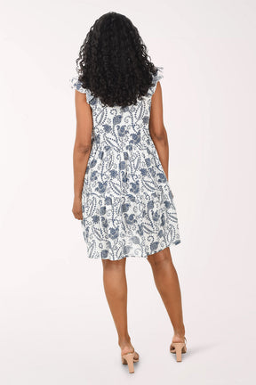 Woman wearing a sleeveless floral dress on a white background