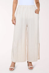 Person wearing white wide-leg pants on a white background