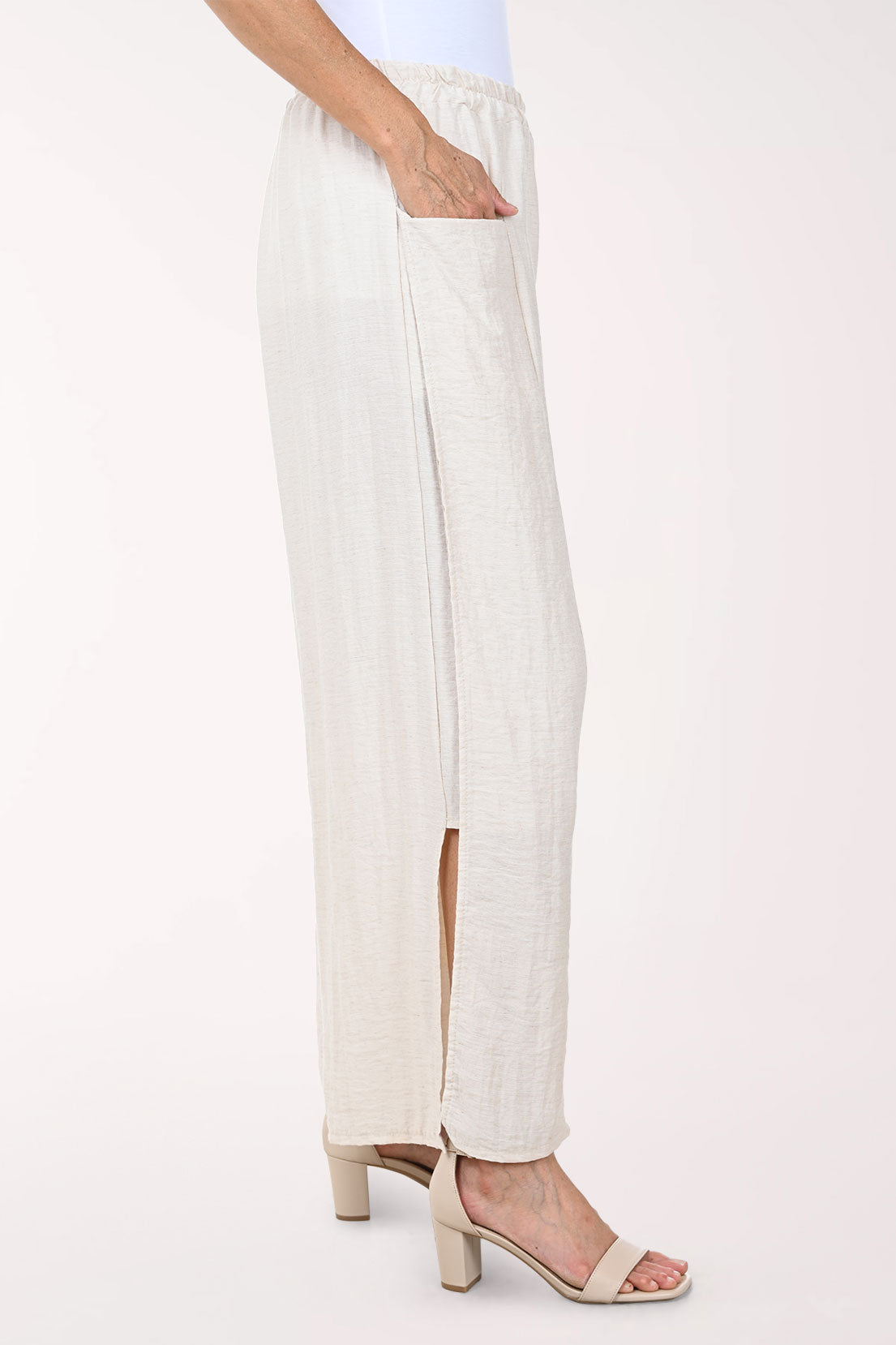 Person wearing white wide-leg pants on a white background