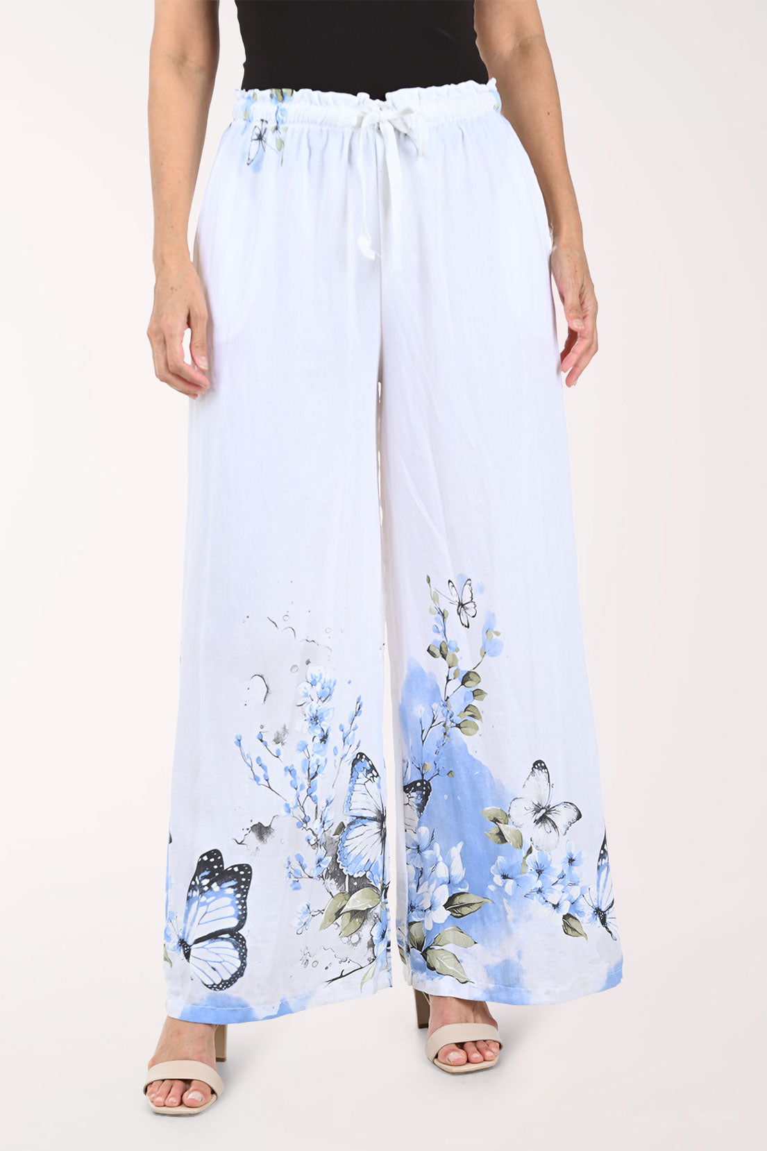 White pants with blue butterfly pattern worn by a person on a white background