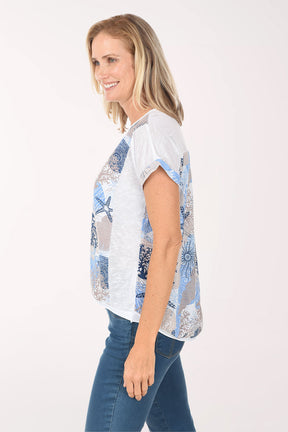 Woman wearing a white t-shirt with blue starfish pattern on a white background