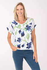 Woman wearing a white t-shirt with blue floral pattern on a white background