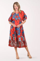 Woman wearing a red floral dress on a white background