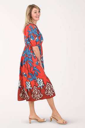 Woman wearing a red floral dress on a white background