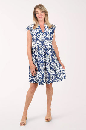 Woman wearing a blue and white patterned dress on a white background