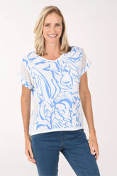 Woman wearing a white t-shirt with blue abstract patterns on a white background