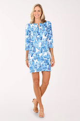 Woman wearing a blue patterned dress on a white background