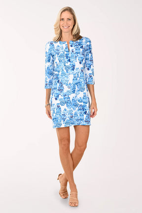 Woman wearing a blue patterned dress on a white background