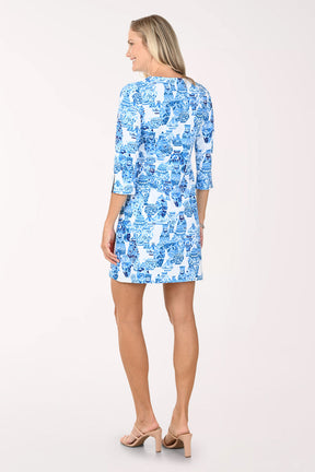 Woman wearing a blue patterned dress on a white background