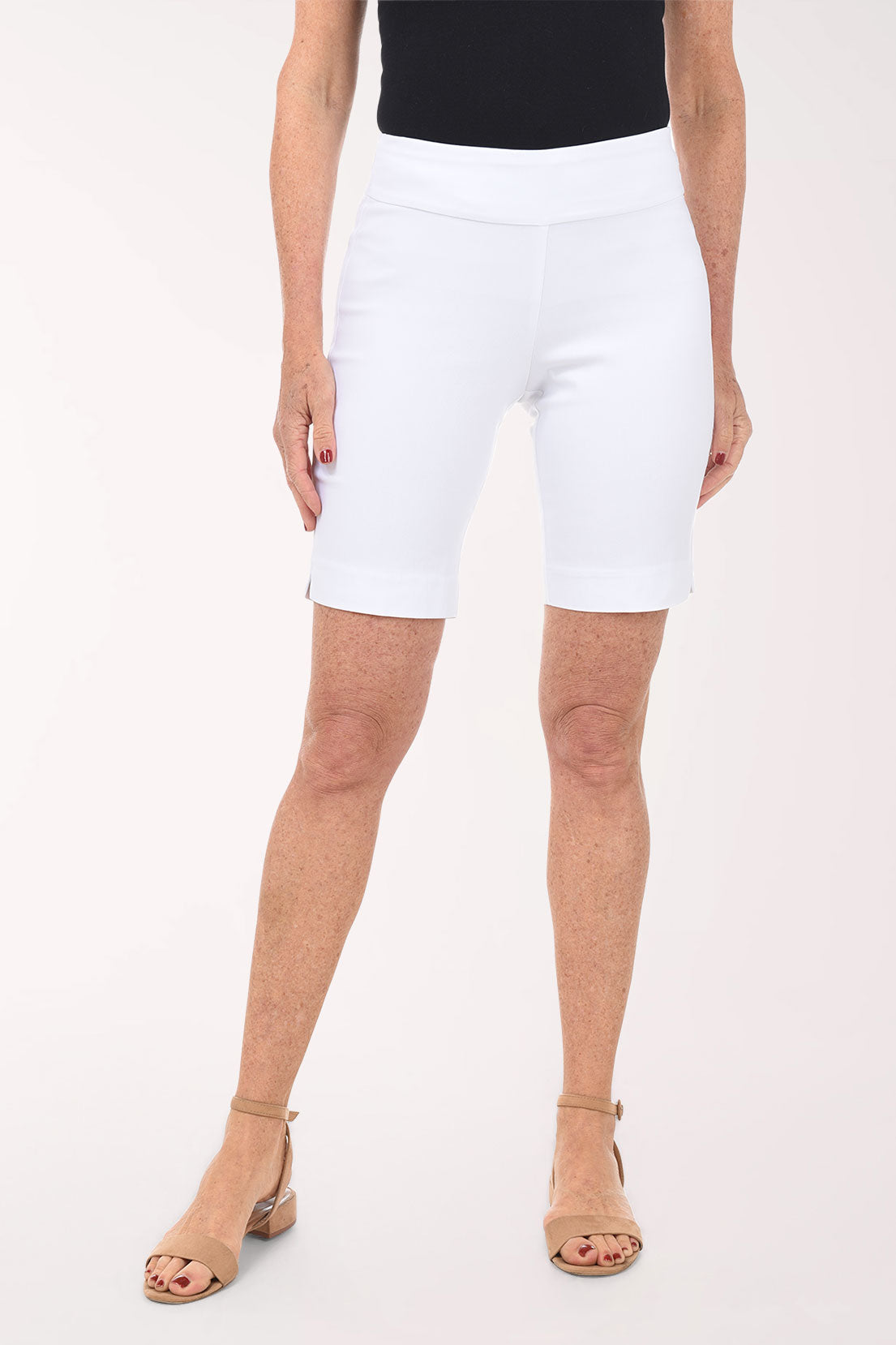 Person wearing white shorts on a plain background