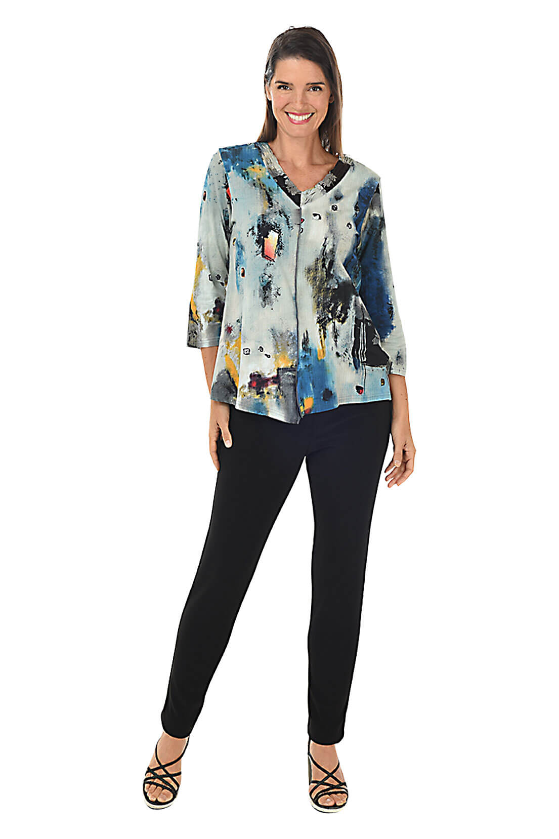 Woman wearing a colorful blouse and black pants on a white background