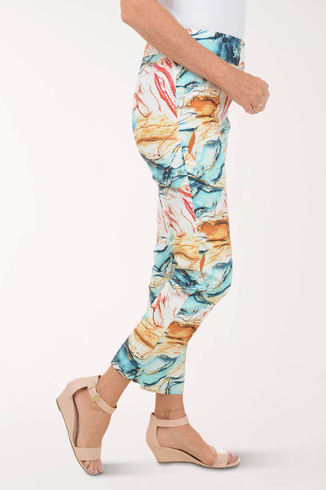 Multicolored abstract patterned pants worn by a person on a white background