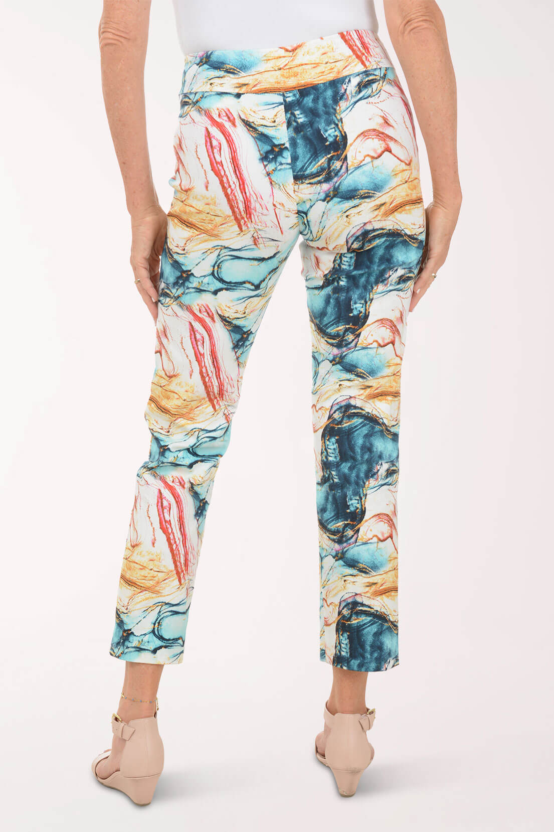 Multicolored abstract patterned pants worn by a person on a white background