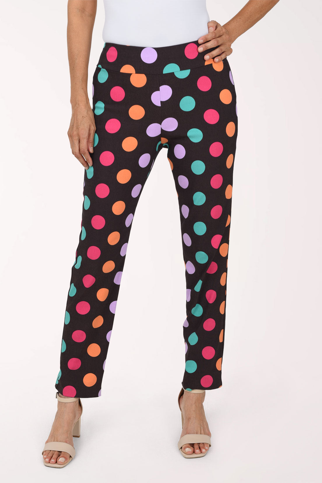 Women wearing black pull-on ankle pants with multicolored dots