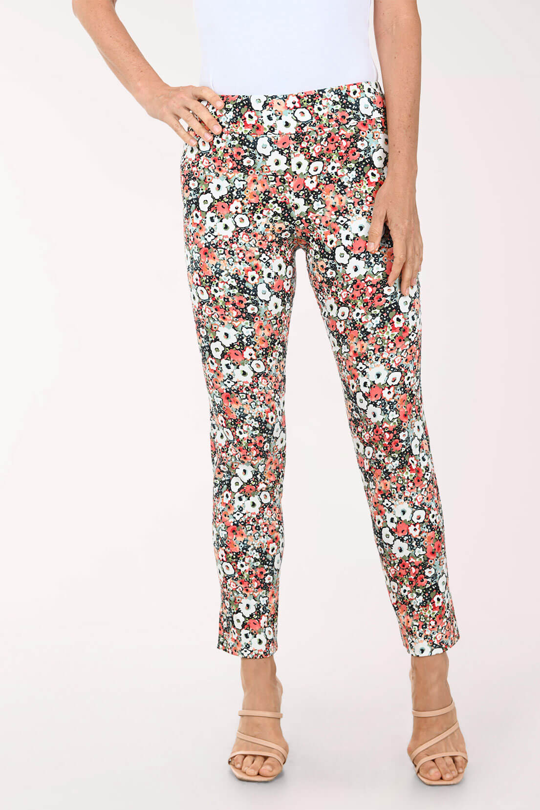 Floral patterned pants worn by a person on a white background
