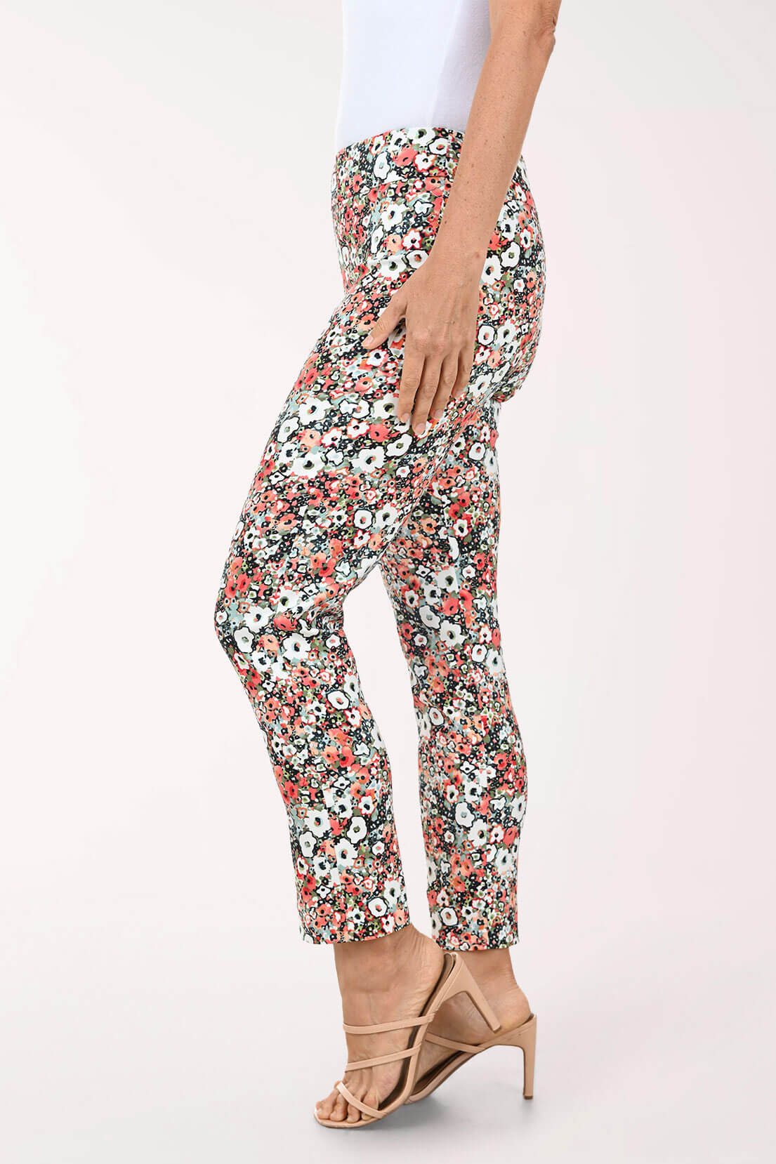 Floral patterned pants worn by a person on a white background
