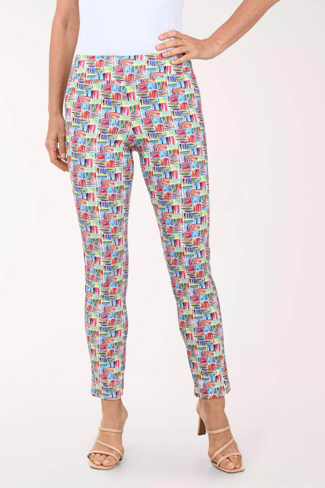 Multicolored patterned pants worn by a person on a white background