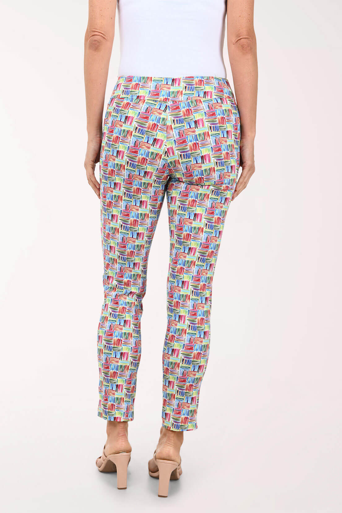 Multicolored patterned pants worn by a person on a white background