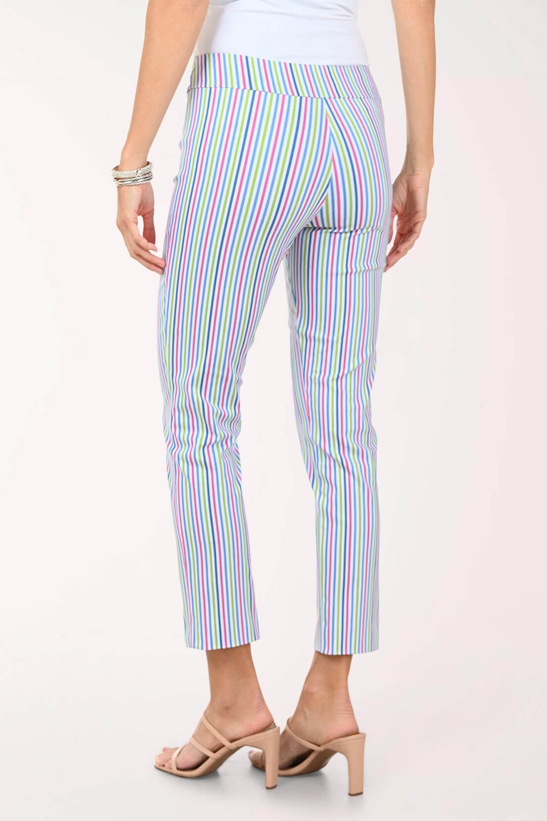 Multicolored striped pants worn by a person on a white background