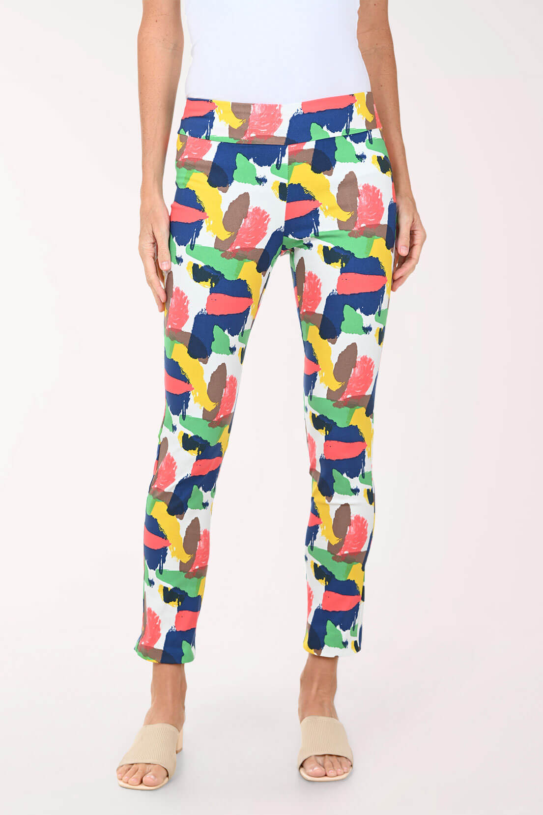 Person wearing colorful patterned pants on a white background