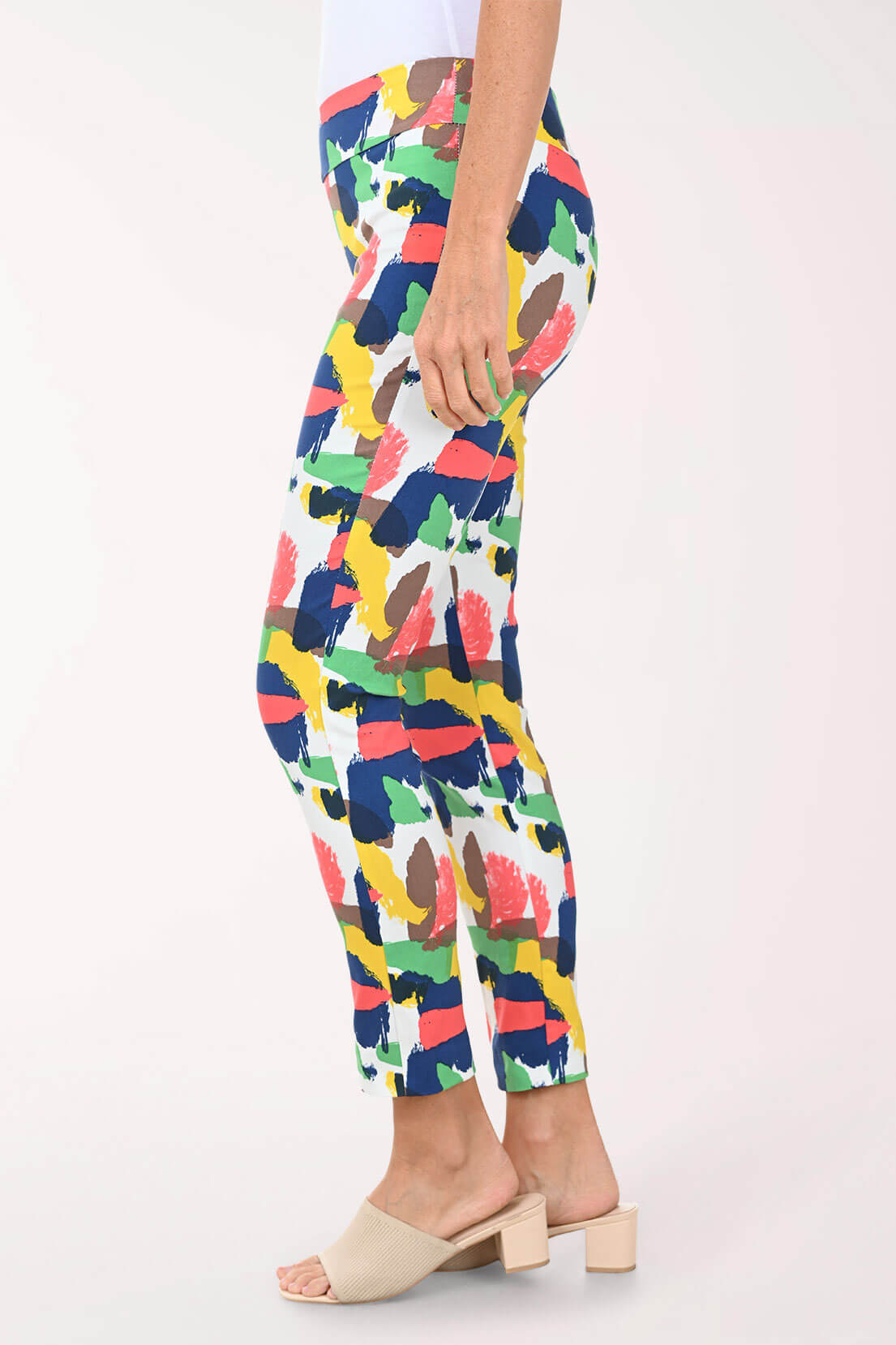 Person wearing colorful patterned pants on a white background