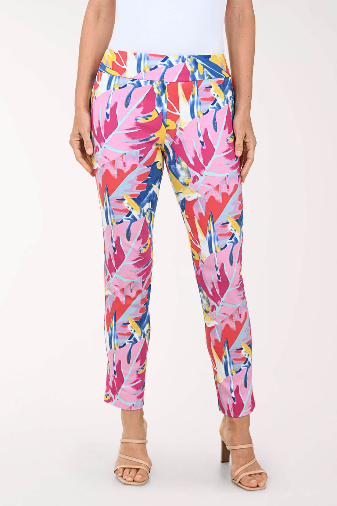 Multicolored tropical print pants worn by a person on a white background