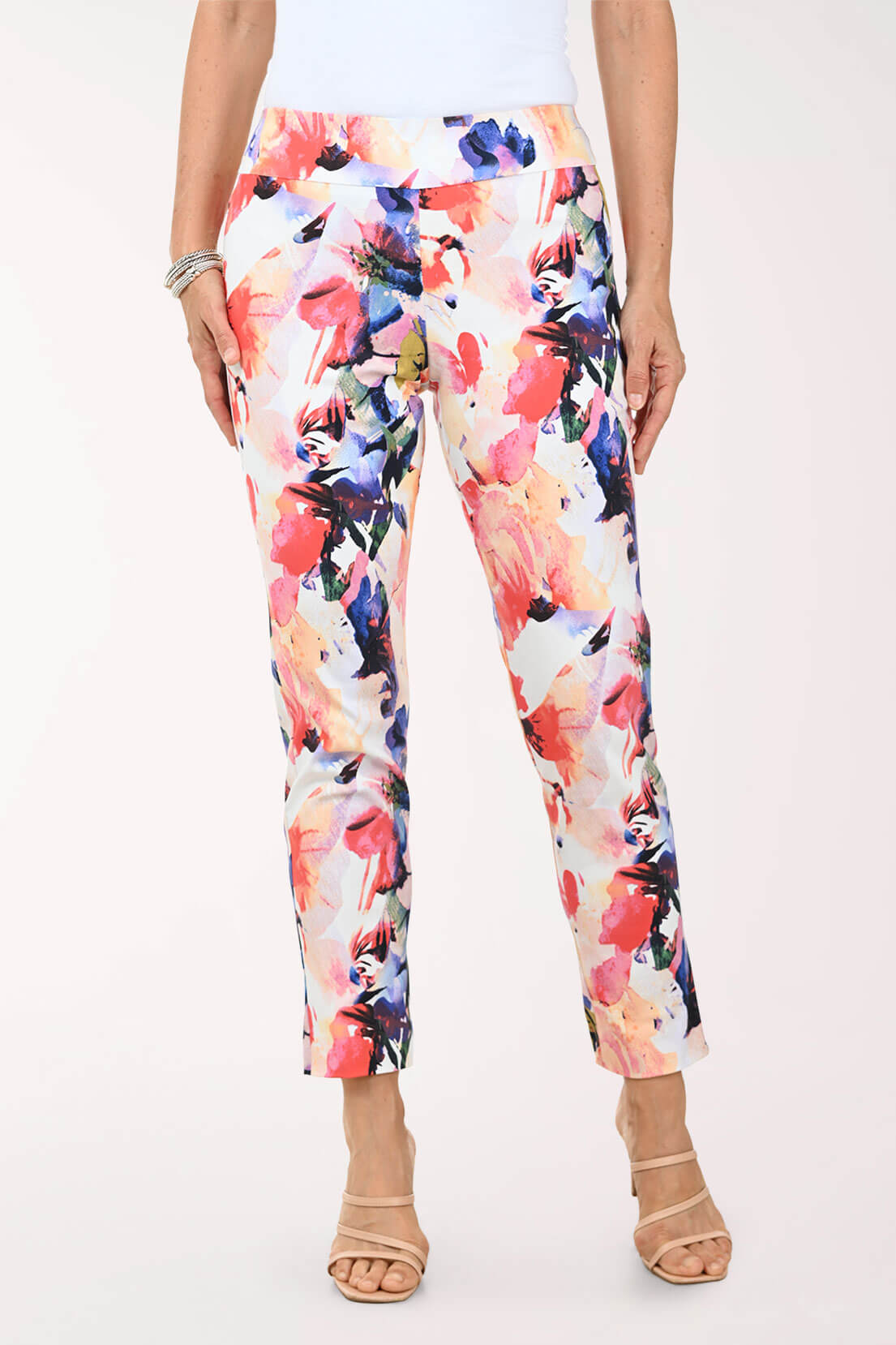 Multicolored floral pants worn by a person on a white background