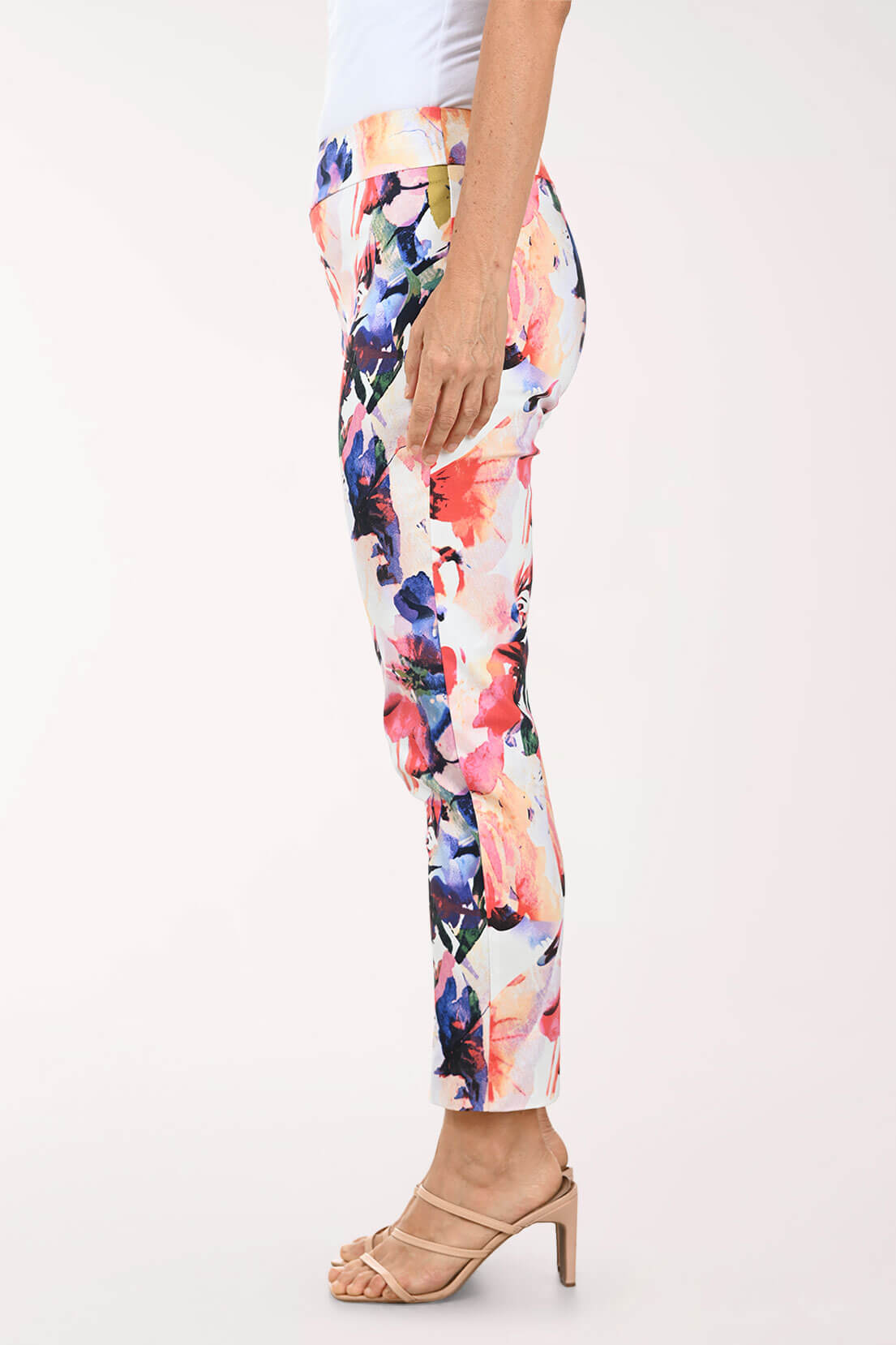 Multicolored floral pants worn by a person on a white background