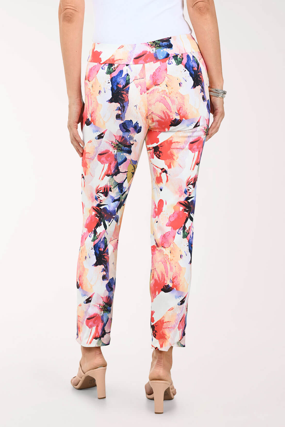 Multicolored floral pants worn by a person on a white background