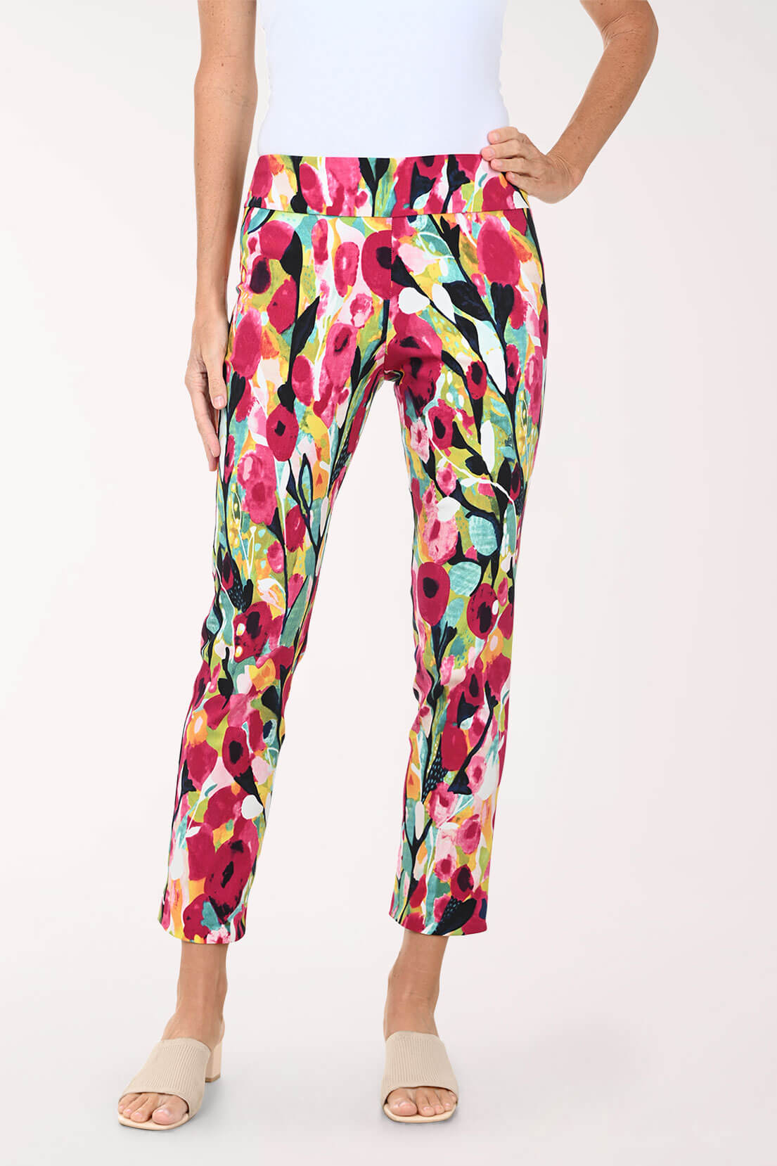 Colorful floral pants worn by a person on a white background