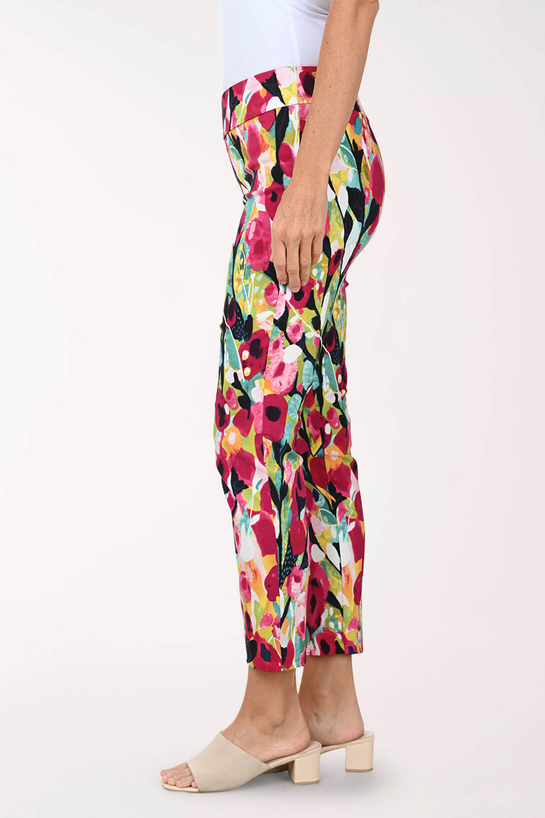Colorful floral pants worn by a person on a white background