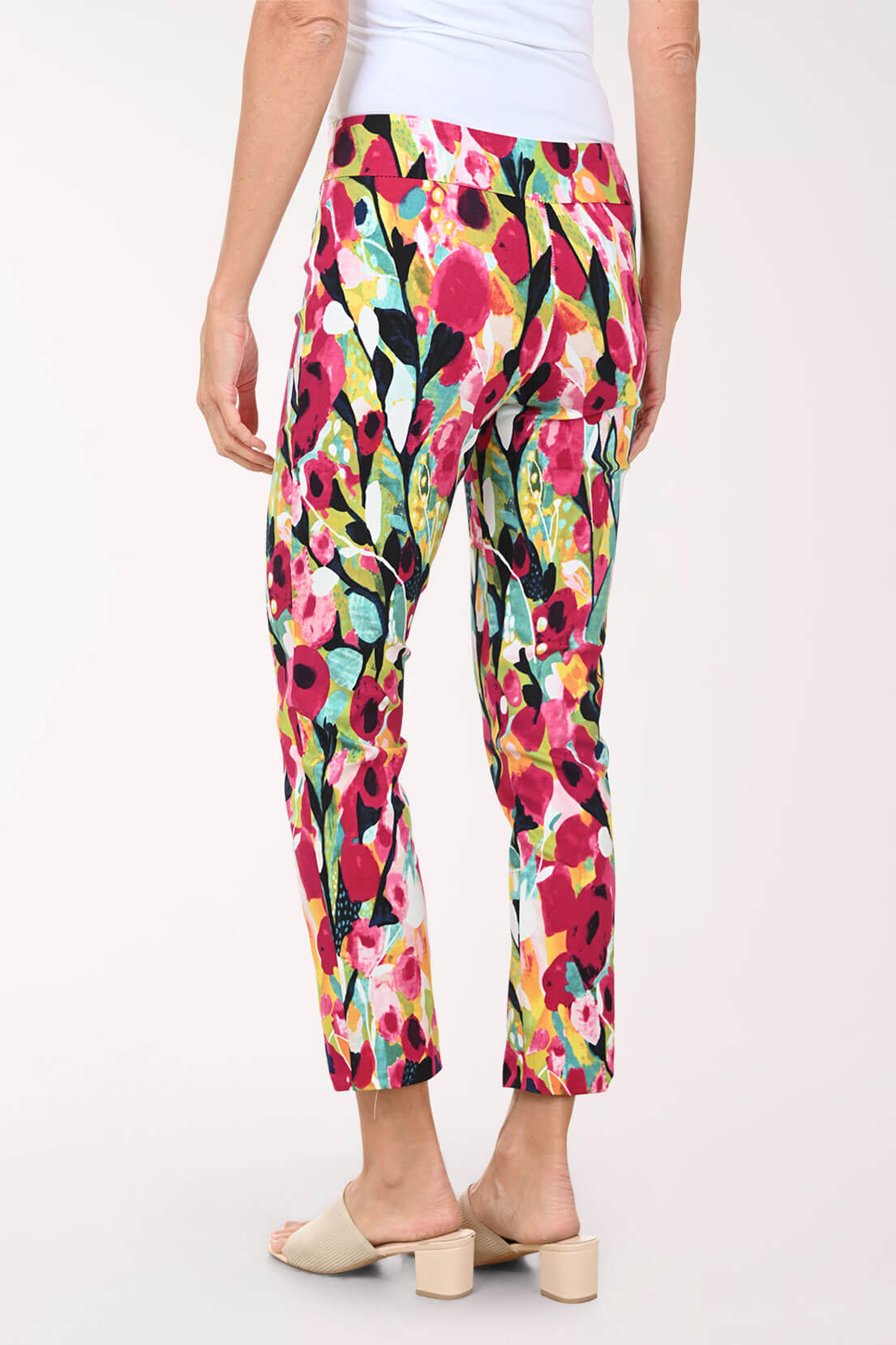Colorful floral pants worn by a person on a white background