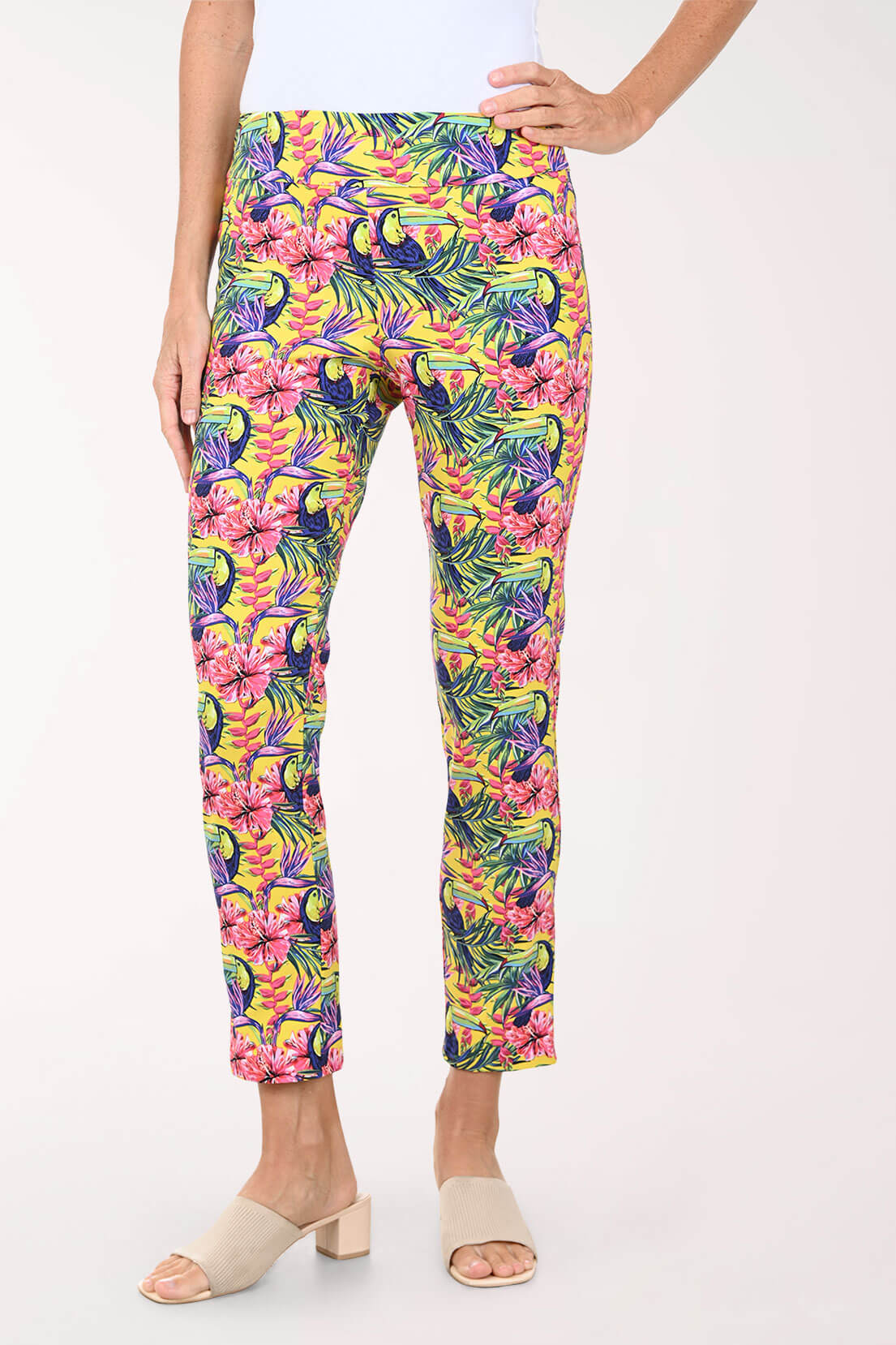 Tropical patterned pants worn by a person on a white background