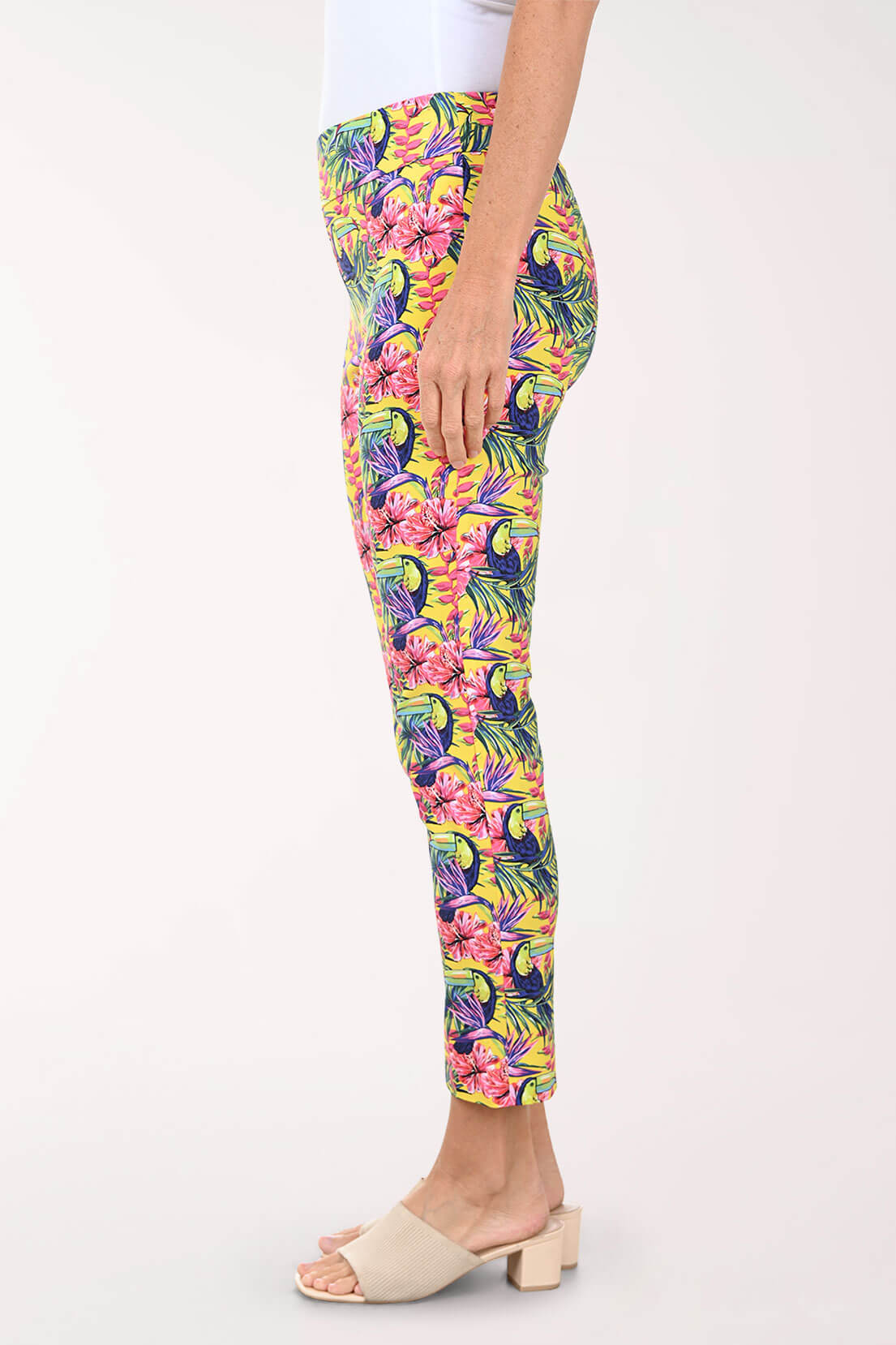 Tropical patterned pants worn by a person on a white background